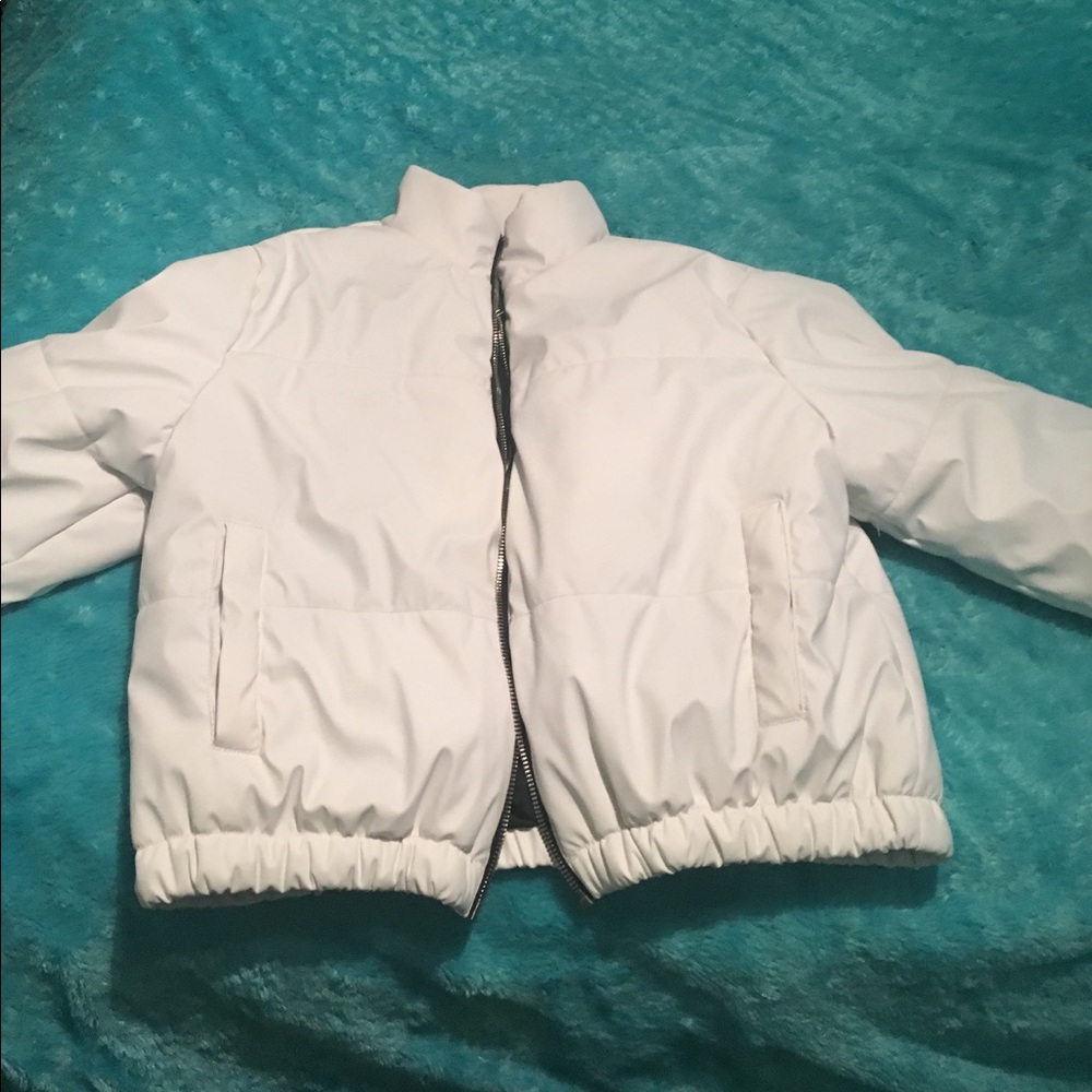 White down jacket with black lining.